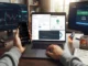 A first-person workspace view of a trader checking a meme coin contract across multiple monitors, showing Etherscan source code, Token Sniffer verification, a liquidity lock checker, and a DEXTools price chart, alongside a smartphone displaying X posts and a notepad with DYOR notes.